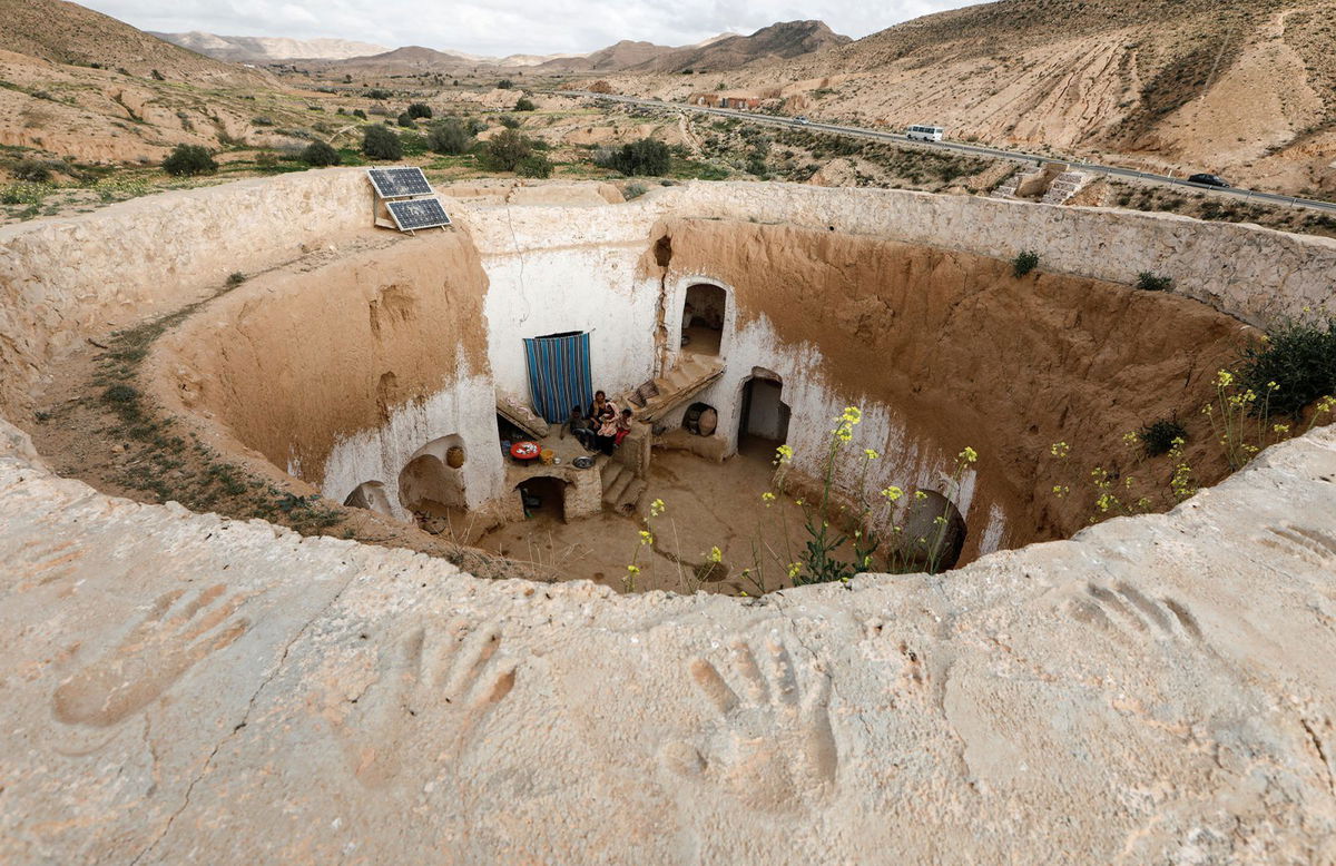 Saliha Mohamedi, 36, sits with her children at their troglodyte house on the outskirts of Matmata, Tunisia, February 4, 2018.