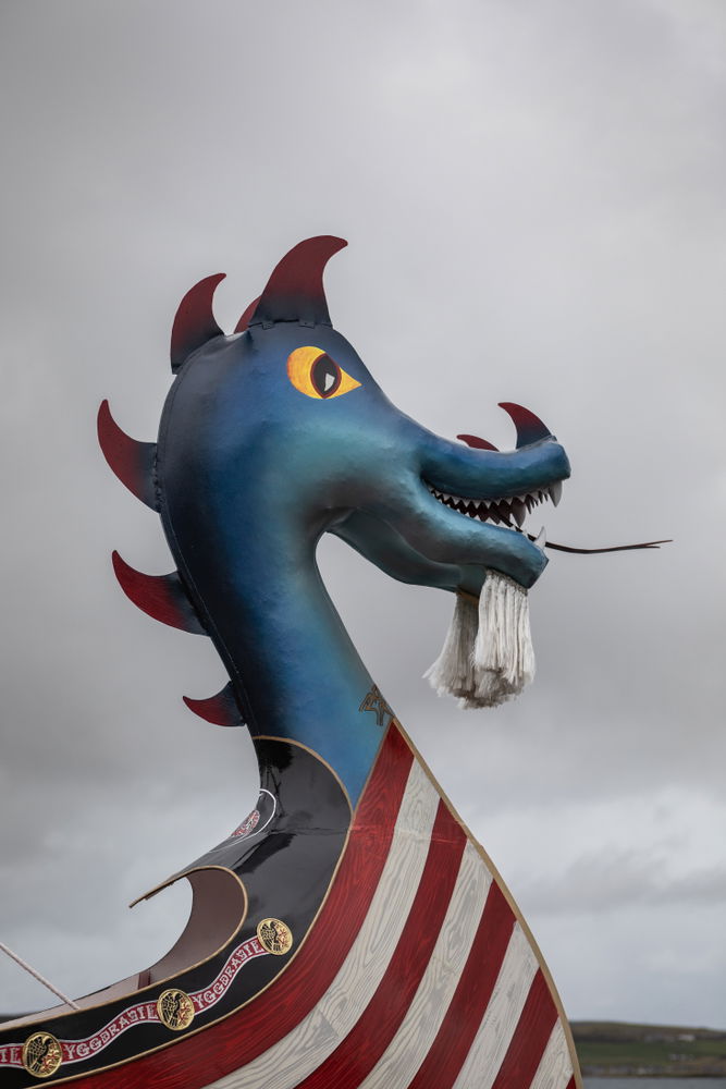 Sky, Head, Sky, Eye, Mythical creature, Water, Watercraft, Cloud, Dinosaur