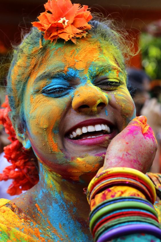 Holi, Face, Smile, Head, Chin, Hairstyle, Eye, Facial expression, Green, Orange, Happy
