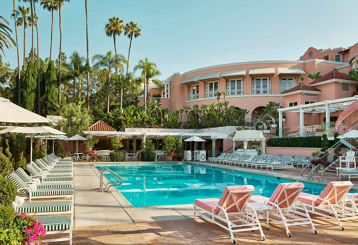 Beverly Hills Hotel Dorchester Collection, Property, Furniture, Plant, Sky, Water, Swimming pool, Chair, Azure, Building, Outdoor furniture